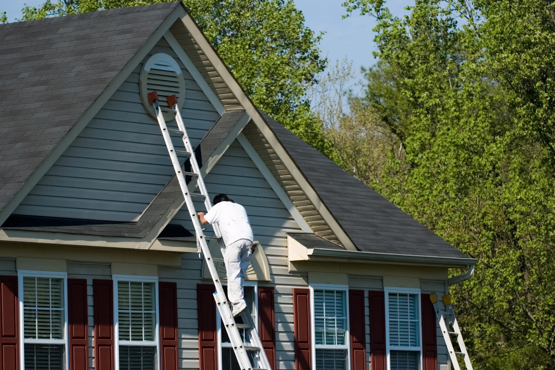 a man on a ladder on a house